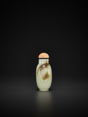 Lot 803 - A CELADON AND RUSSET JADE ‘LION MASK’ SNUFF BOTTLE, MID-QING