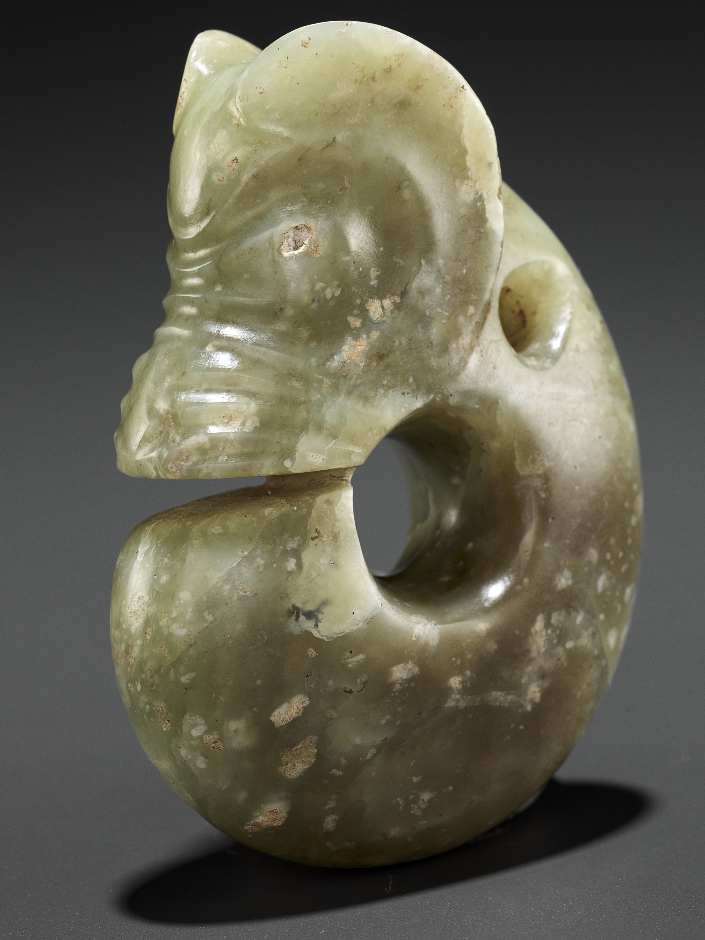 Lot 203 - A CELADON JADE ‘PIG-DRAGON’ PENDANT, ZHULONG,