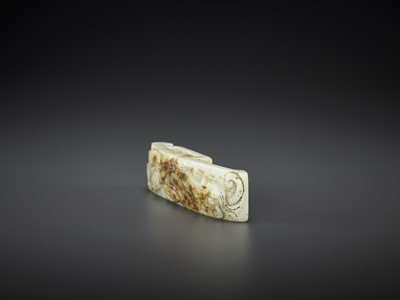 AN ARCHASITIC JADE SCABBARD SLIDE WITH DRAGON AMID CLOUDS, EARLY MING