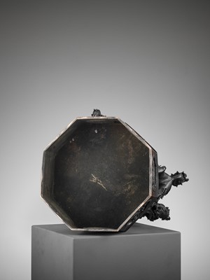 Lot 17 - A RARE TEMPLE LAMP OF BRONZE SHISHI SUPPORTING A BROCADE BALL