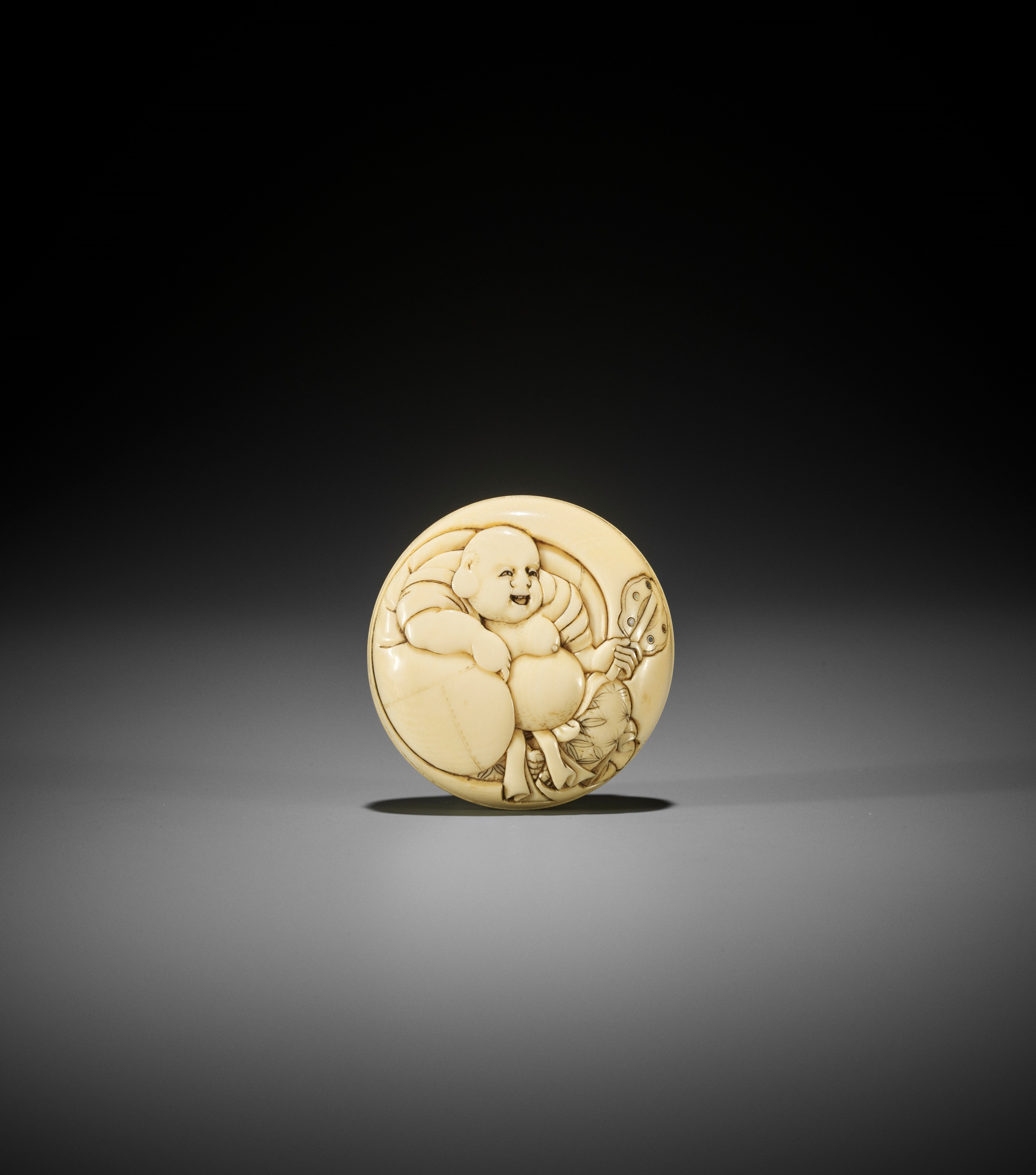 Lot 237 - KIKUGAWA: AN INLAID IVORY MANJU NETSUKE