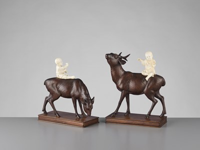 Lot 84 - TOSHIYUKI: A PAIR OF WOOD AND IVORY OKIMONO WITH BOYS ON DEER