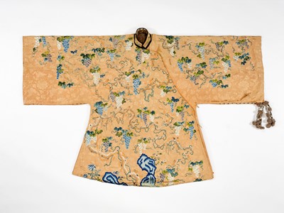 Lot 610 - AN APRICOT-GROUND EMBROIDERED SILK ‘SQUIRRELS AND GRAPES’ ROBE, QING DYNASTY