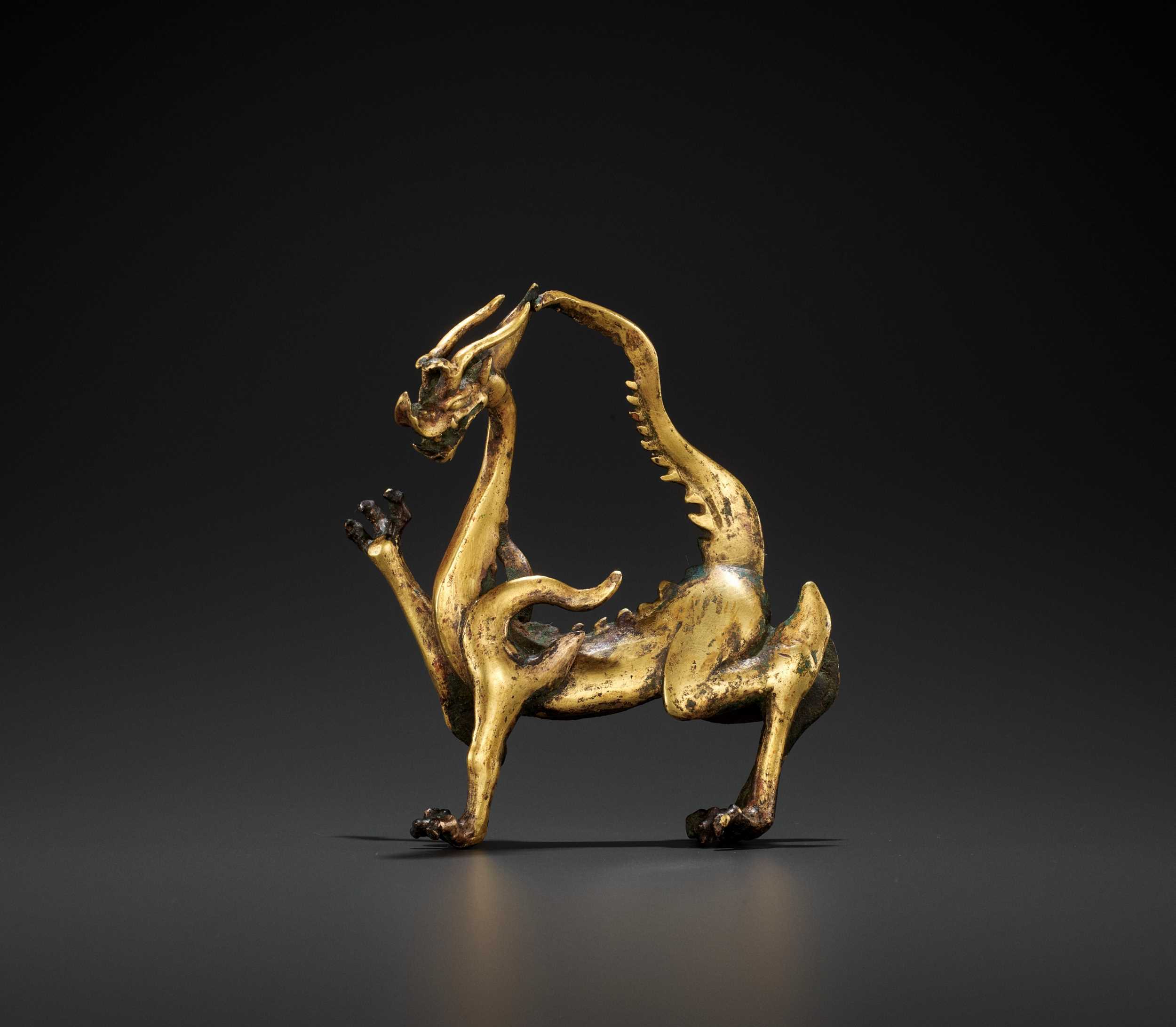 Lot 428 - A RARE GILT BRONZE FIGURE OF A DRAGON, TANG DYNASTY