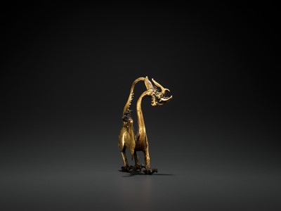 Lot 428 - A RARE GILT BRONZE FIGURE OF A DRAGON, TANG DYNASTY