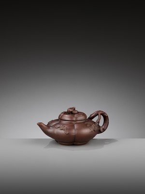 Lot 940 - A YIXING ‘BATS AND PEACHES’ LOBED TEAPOT AND COVER, SIGNED WANG XIUHUA