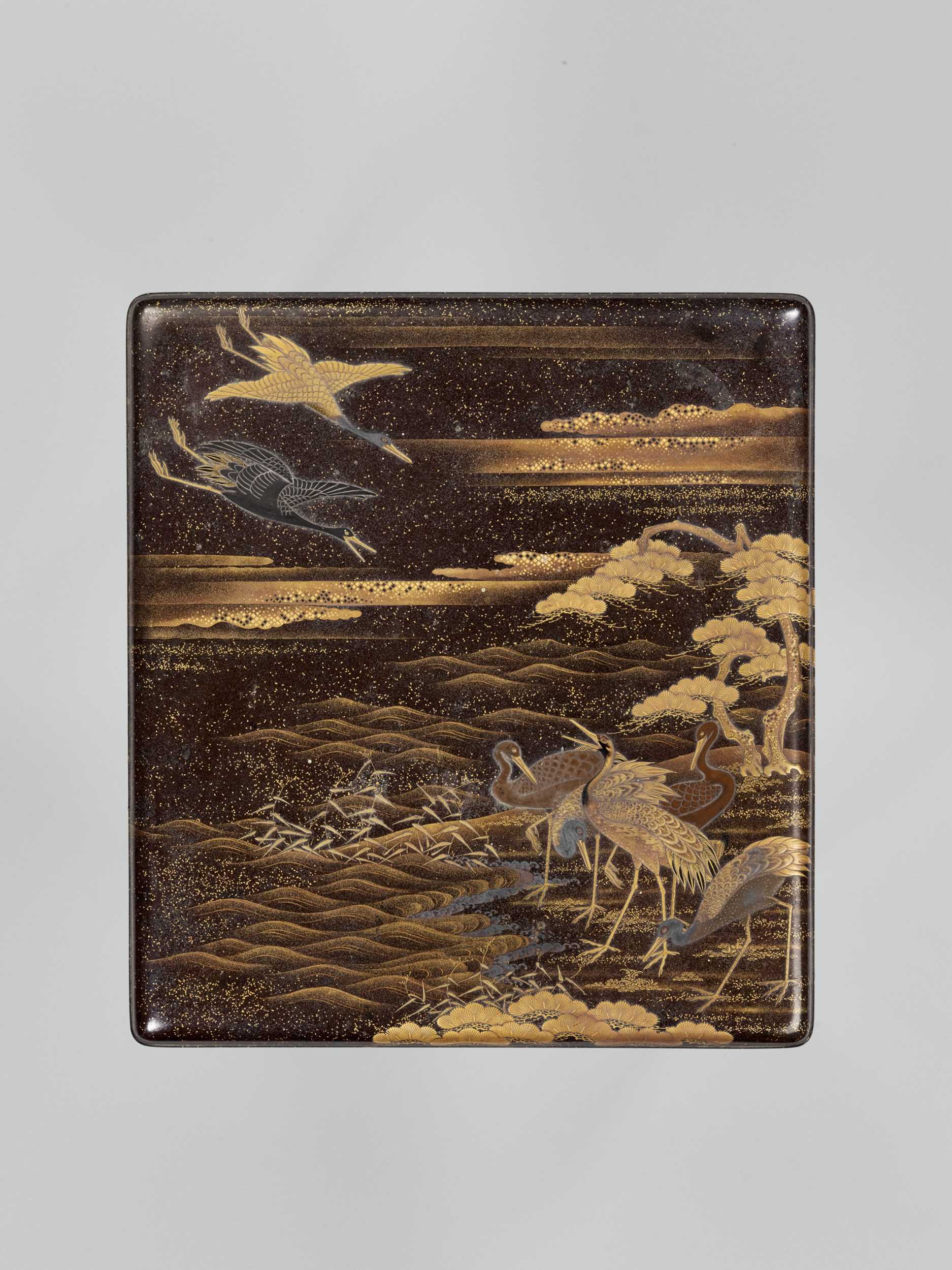 Lot 99 - A LACQUER SUZURIBAKO DEPICTING CRANES, WITH WRITING UTENSILS