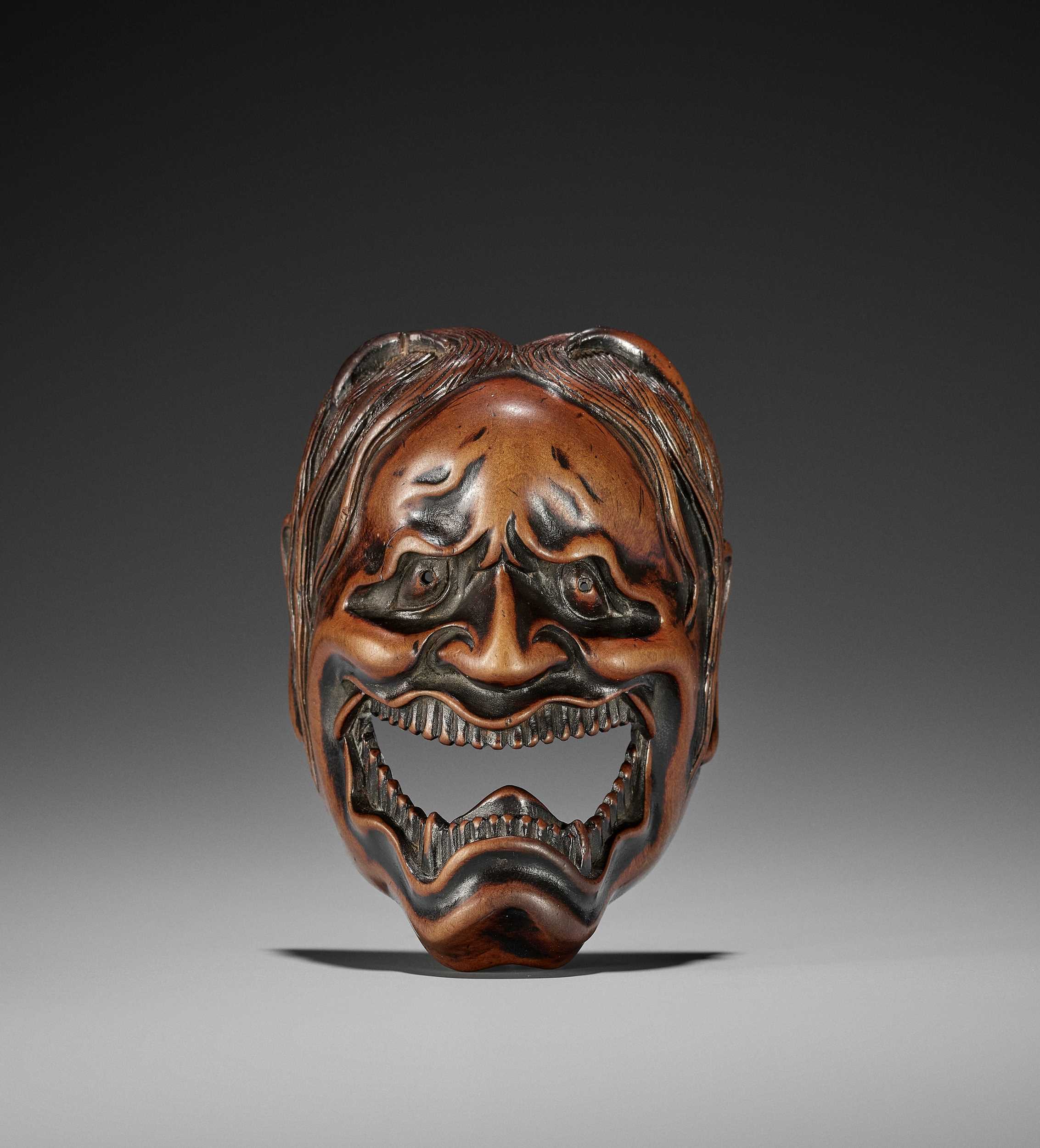 Lot 84 - A SPECTACULAR AND LARGE WOOD MASK NETSUKE OF A FEMALE DEMON