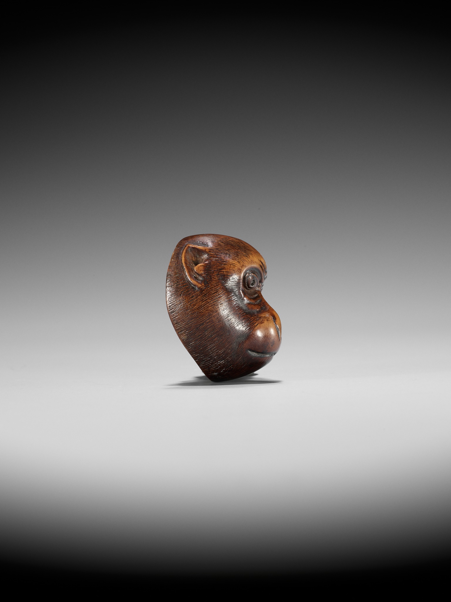 Lot 248 - IKKO: A WOOD KYOGEN MASK NETSUKE OF A MONKEY