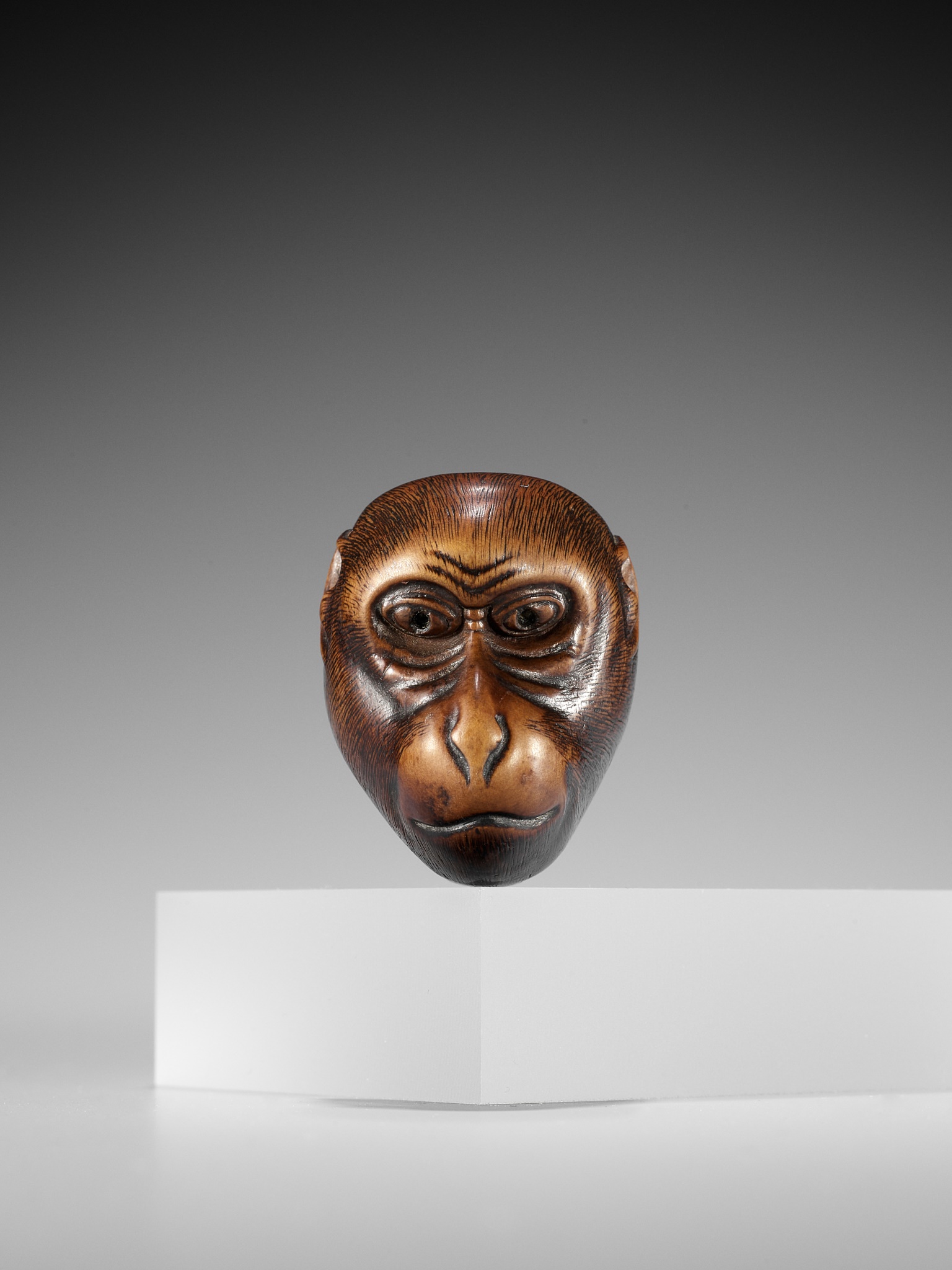Lot 248 - IKKO: A WOOD KYOGEN MASK NETSUKE OF A MONKEY