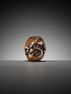 AN IMPORTANT EARLY WOOD MASK NETSUKE DEPICTING A GRIMACING MAN