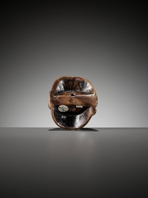 AN IMPORTANT EARLY WOOD MASK NETSUKE DEPICTING A GRIMACING MAN