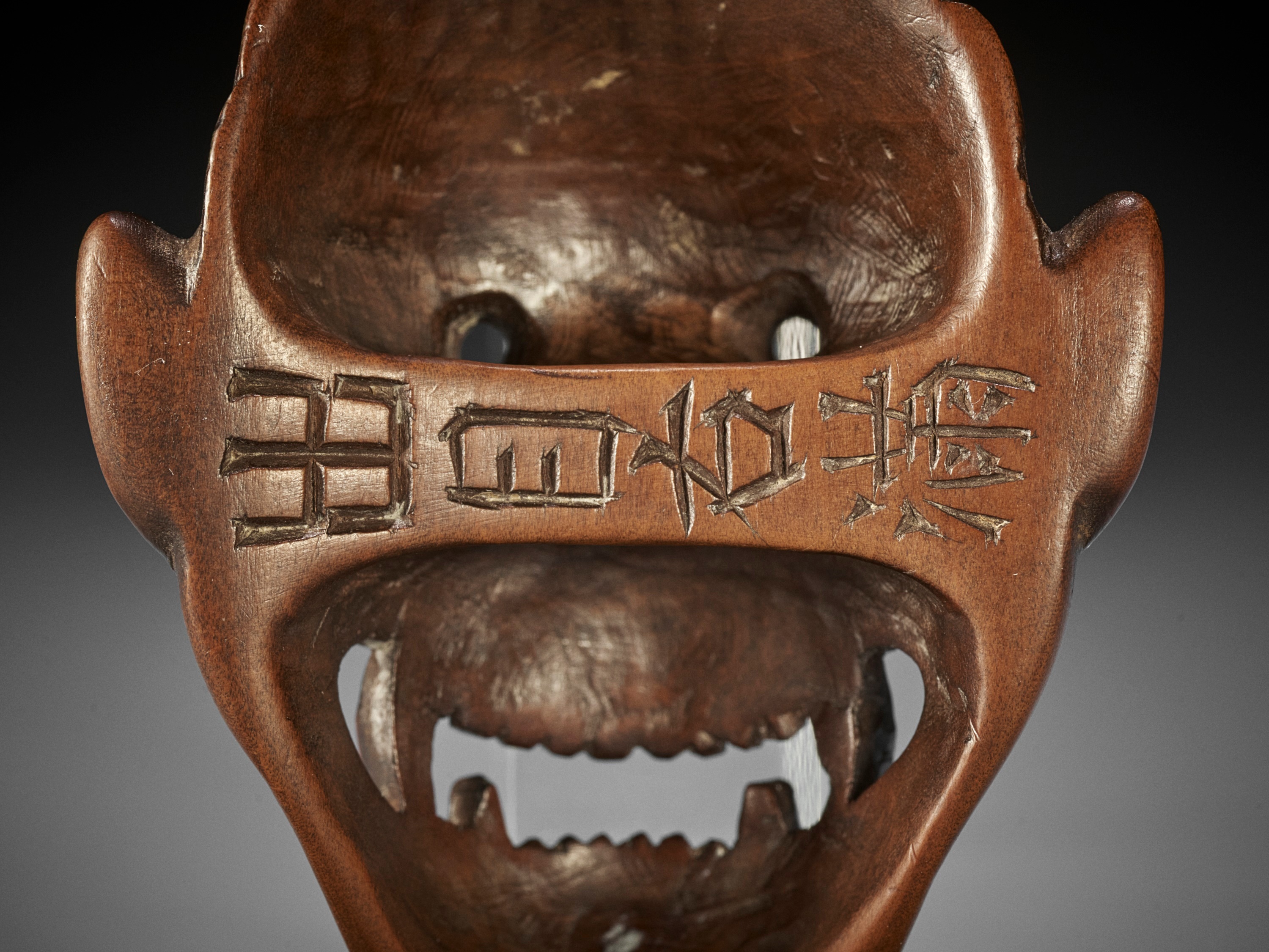 Lot 288 - DEME UMAN: A RARE WOOD MASK NETSUKE OF FUJIN