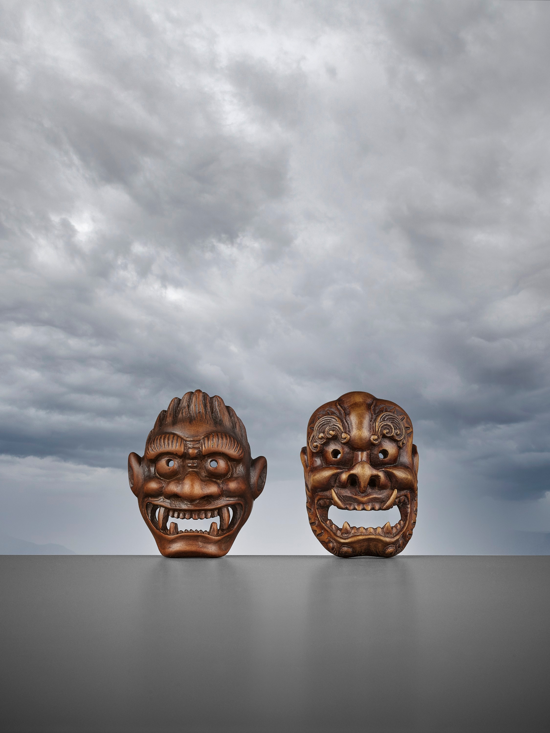 Lot 288 - DEME UMAN: A RARE WOOD MASK NETSUKE OF FUJIN