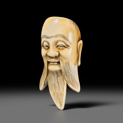 Lot 291 - AN IMPRESSIVE IVORY MASK NETSUKE OF SHOULAO