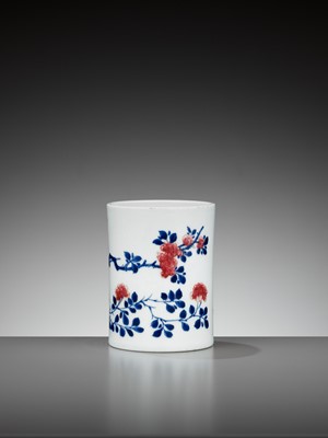 Lot 241 - AN UNDERGLAZE-BLUE, COPPER-RED AND CELADON-GLAZED CARVED BRUSHPOT, QING DYNASTY