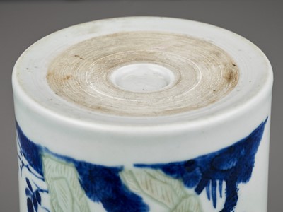 Lot 241 - AN UNDERGLAZE-BLUE, COPPER-RED AND CELADON-GLAZED CARVED BRUSHPOT, QING DYNASTY