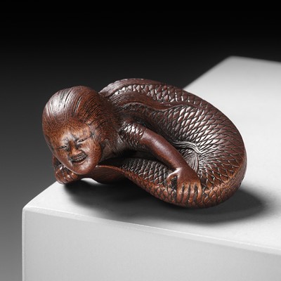 Lot 118 - TADATOSHI: A SUPERB NAGOYA SCHOOL WOOD NETSUKE OF A NINGYO (MERMAID)