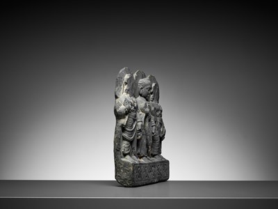 Lot 544 - A GRAY SCHIST RELIEF OF BUDDHA AND TWO BODHISATTVAS, GANDHARA