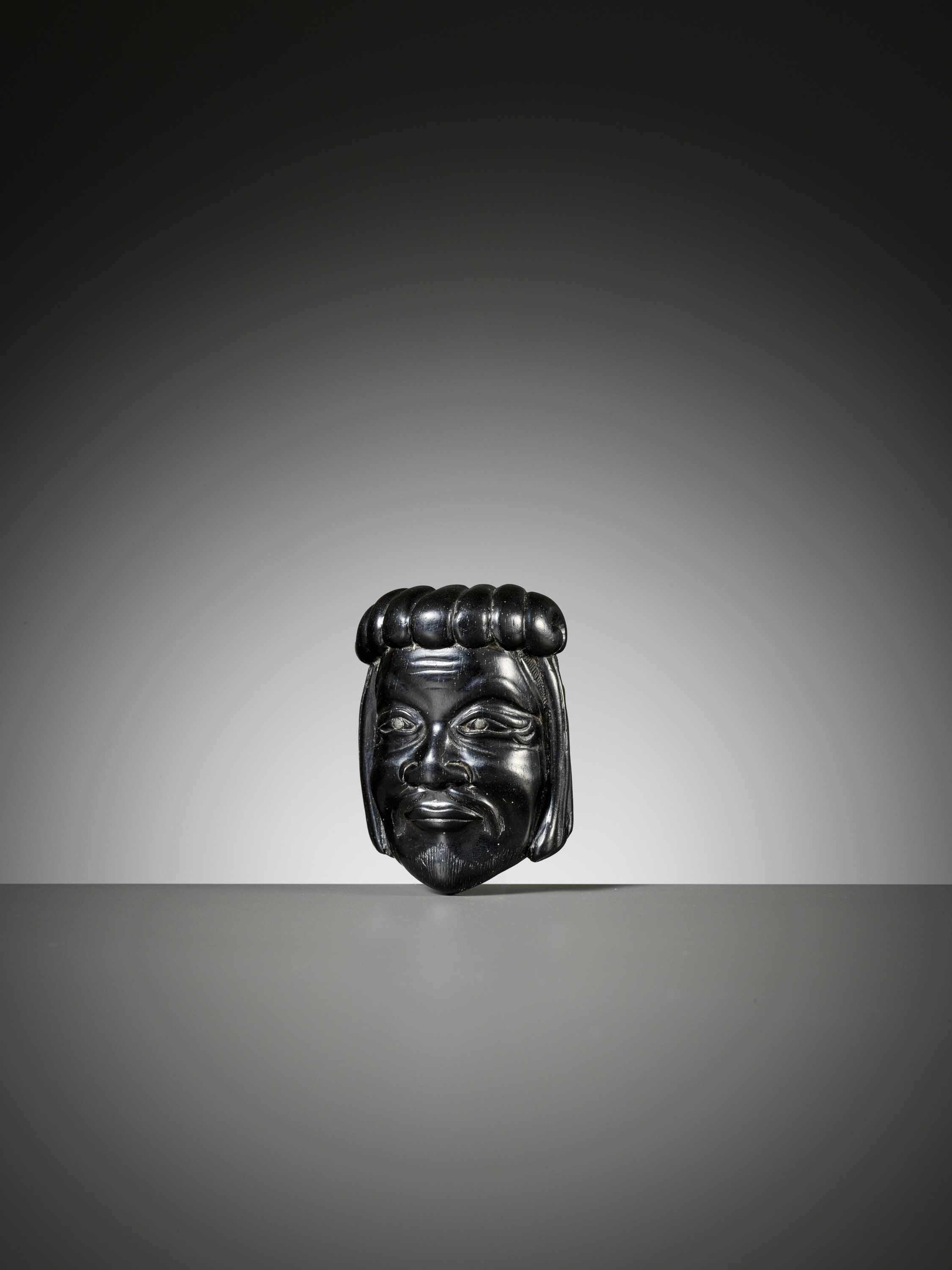 Lot 289 - A RARE EBONY GYODO (RELIGIOUS) MASK NETSUKE