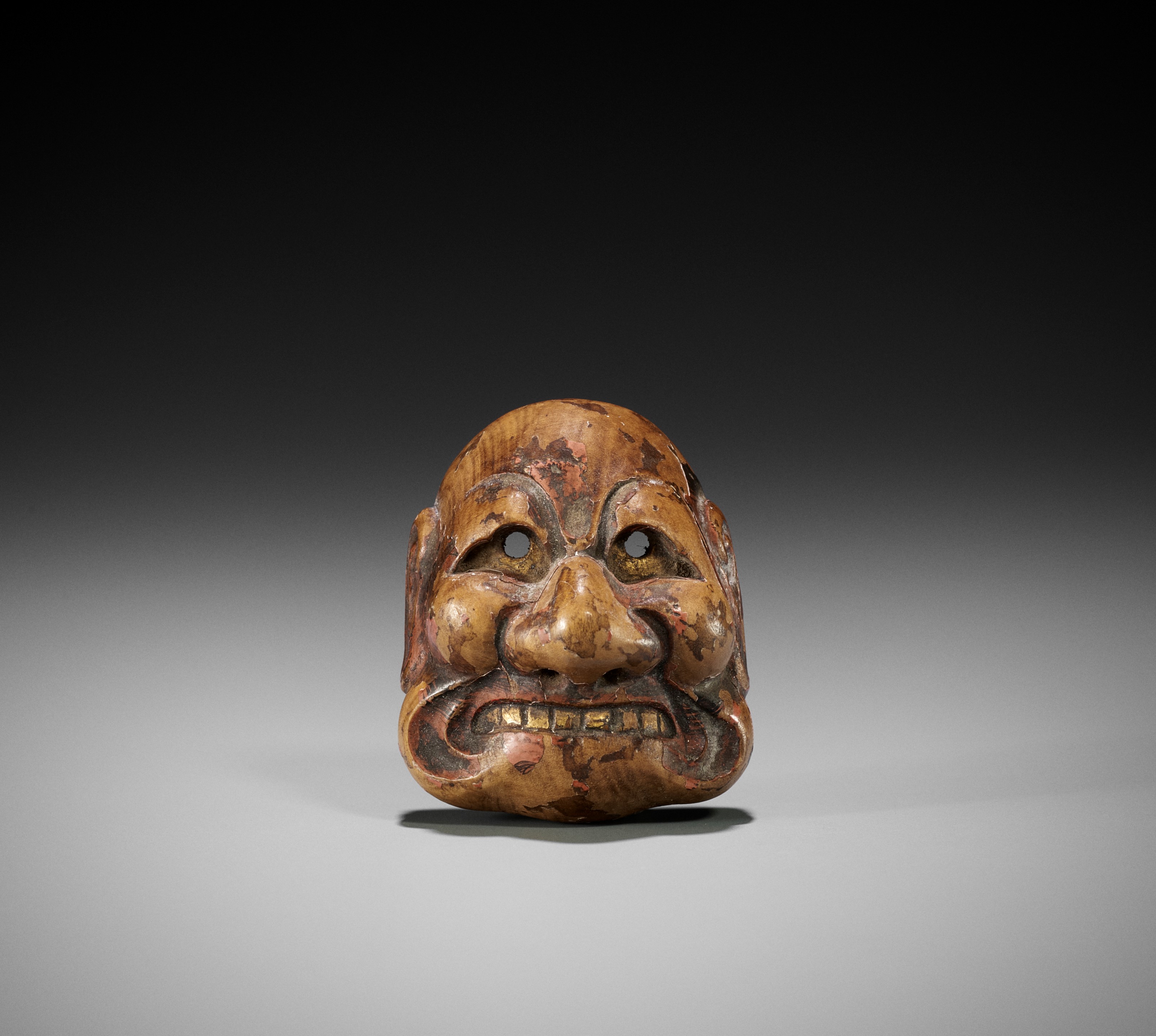 Lot 291 - KANO TESSAI: A LACQUERED WOOD MASK NETSUKE