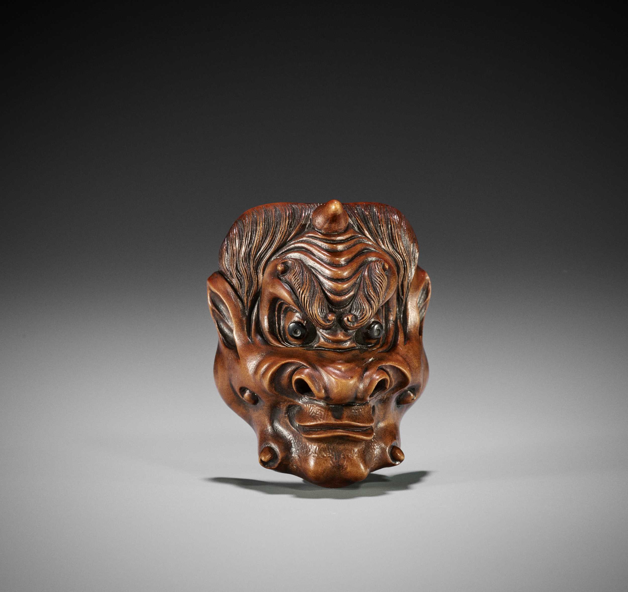 Lot 287 - A WOOD MASK NETSUKE OF FUJIN