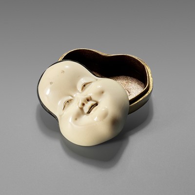 YOZEI: A RARE LACQUERED IVORY HAKO (BOX) AND COVER IN THE FORM OF AN OKAME MASK, DATED 1705 BY INSCRIPTION