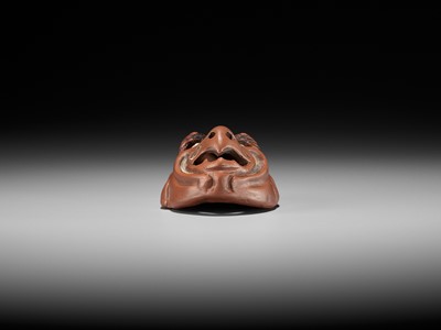 Lot 496 - SEKISEN: AN ONKO POTTERY MASK NETSUKE OF TOBI, KO-TENGU