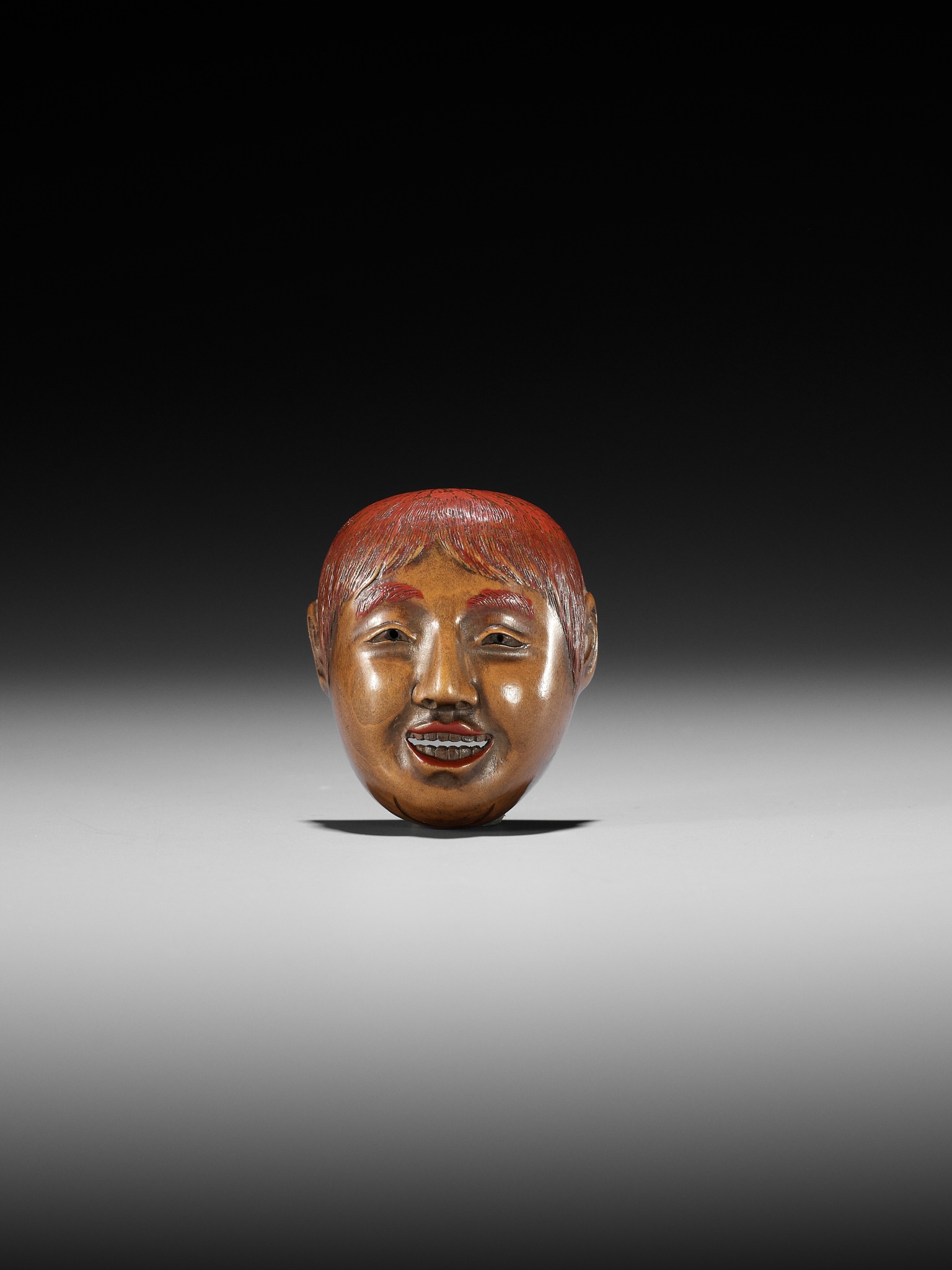 Lot 501 - HO RAKUMIN: A WOOD AND LACQUER MASK NETSUKE