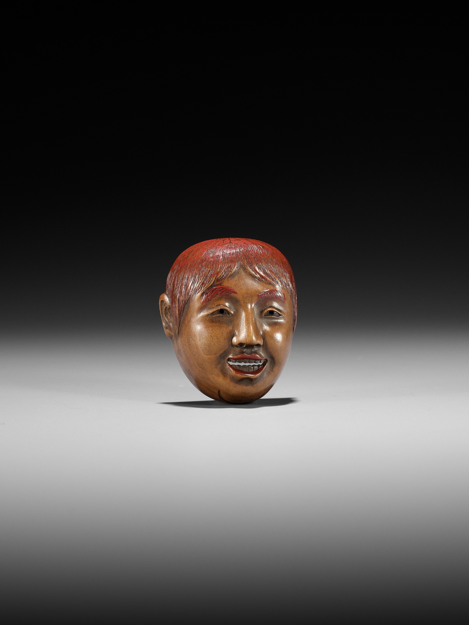 Lot 501 - HO RAKUMIN: A WOOD AND LACQUER MASK NETSUKE