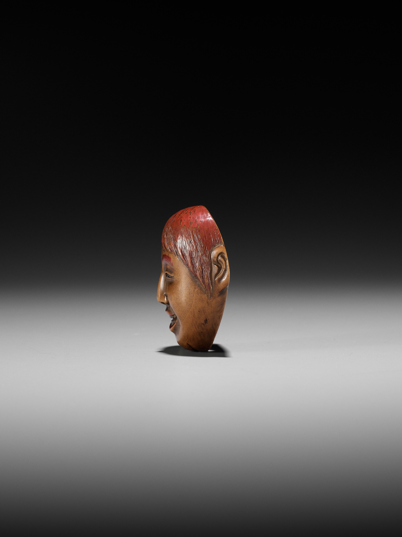 Lot 501 - HO RAKUMIN: A WOOD AND LACQUER MASK NETSUKE