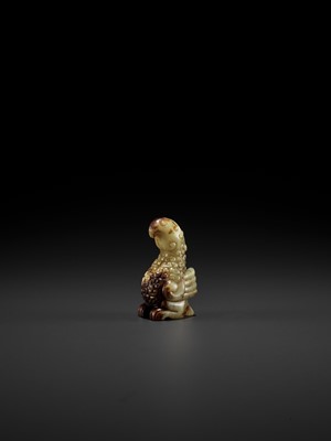 Lot 62 - A YELLOW AND RUSSET JADE FIGURE OF A PHOENIX, EASTERN ZHOU
