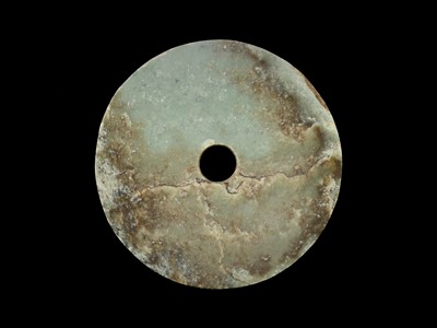 Lot 61 - AN EXCEPTIONALLY LARGE PALE GREEN AND RUSSET JADE BI DISC, EARLY BRONZE AGE