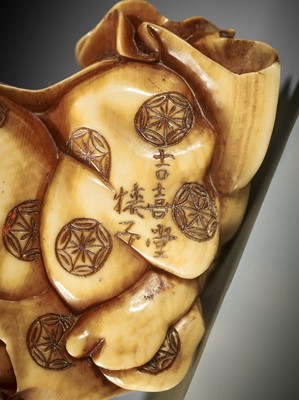 Lot 247 - SARUKO: A STAINED IVORY NETSUKE OF A CALLIGRAPHER