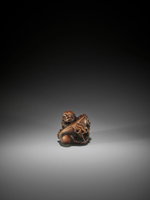 Lot 57 - A POWERFUL AND RARE WOOD NETSUKE OF A COILED DRAGON, ATTRIBUTED TO MITSUHARU