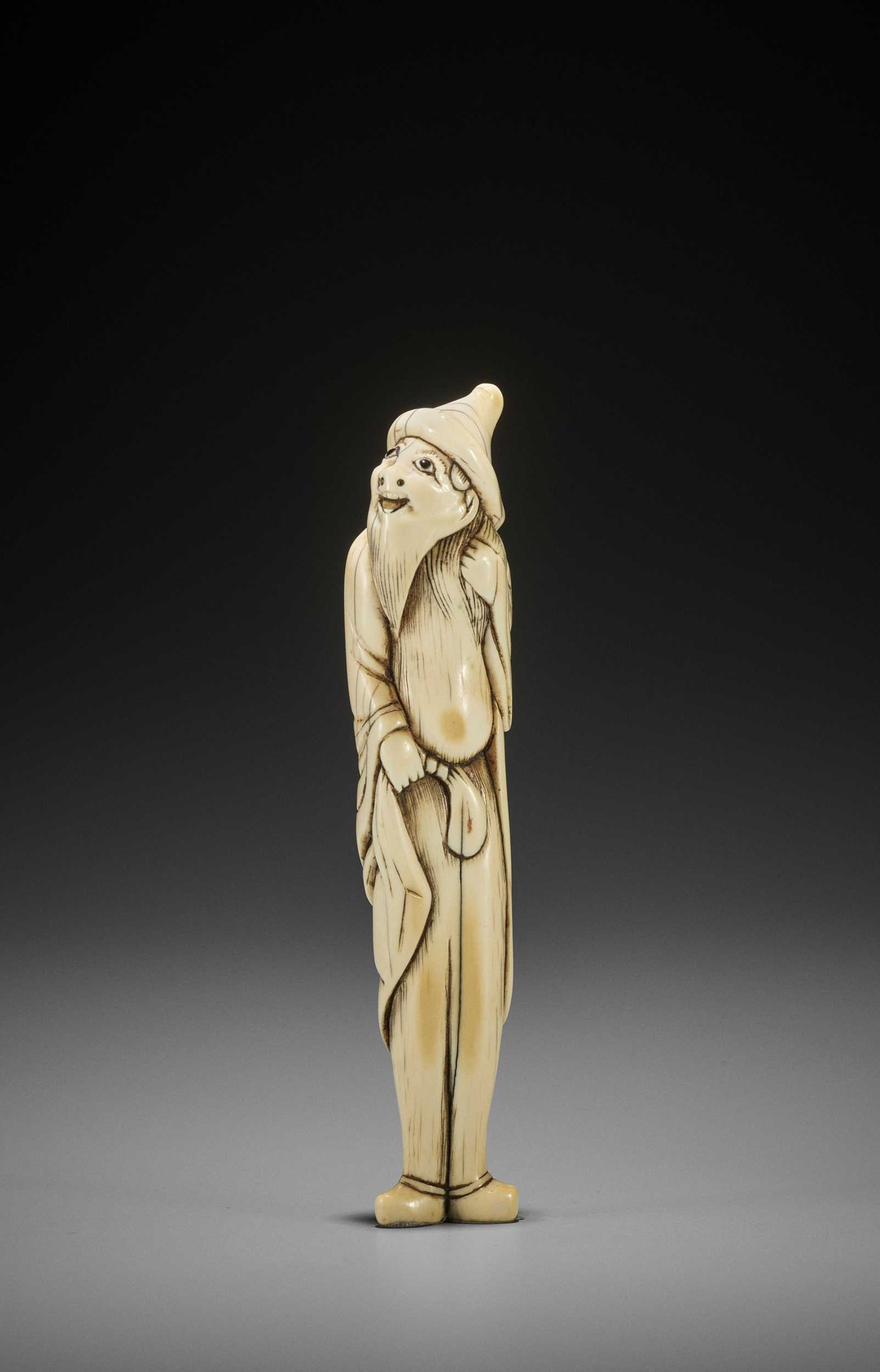 Lot 24 - A RARE AND TALL IVORY NETSUKE OF A FOREIGNER