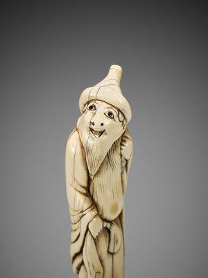 Lot 24 - A RARE AND TALL IVORY NETSUKE OF A FOREIGNER