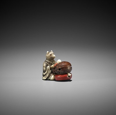 Lot 246 - RYUHEI: AN IVORY AND WOOD NETSUKE OF A FOX PRIEST BEATING A MOKUGYO