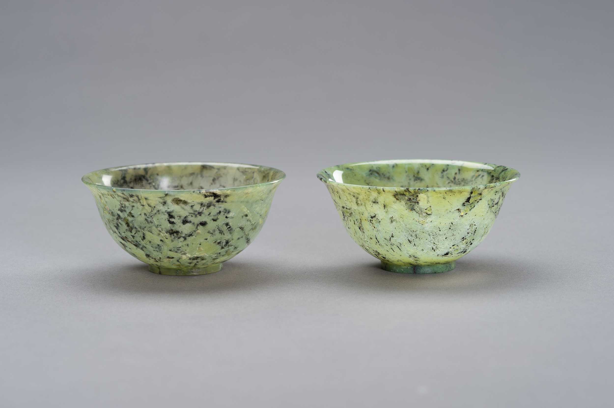 Lot 296 - A MOTTLED PAIR OF JADE BOWLS