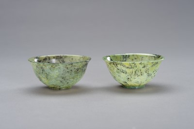 Lot 296 - A MOTTLED PAIR OF JADE BOWLS