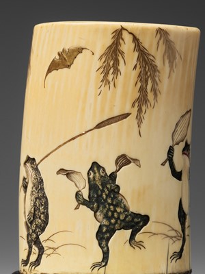 Lot 132 - A LACQUERED AND CARVED IVORY ‘FROG PROCESSION’ TUSK VASE