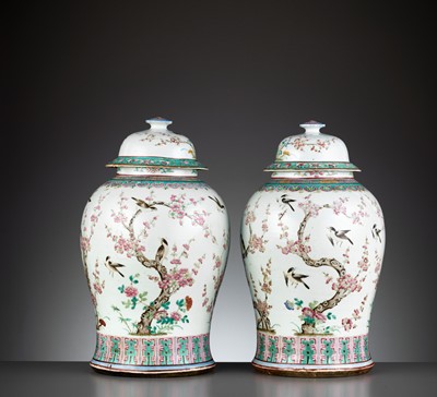 Lot 285 - A PAIR OF LARGE FAMILLE ROSE ‘MAGPIES AND PRUNUS’ BALUSTER VASES AND COVERS, QING DYNASTY