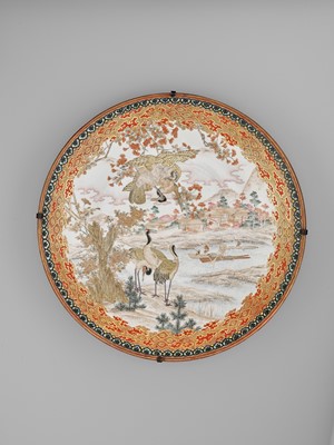Lot 88 - A LARGE ENAMELED KUTANI PORCELAIN CHARGER WITH FALCON AND CRANES