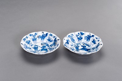 Lot 325 - A PAIR OF BLUE AND WHITE ‘LADY IN GARDEN’ LOBED DISHES, KANGXI
