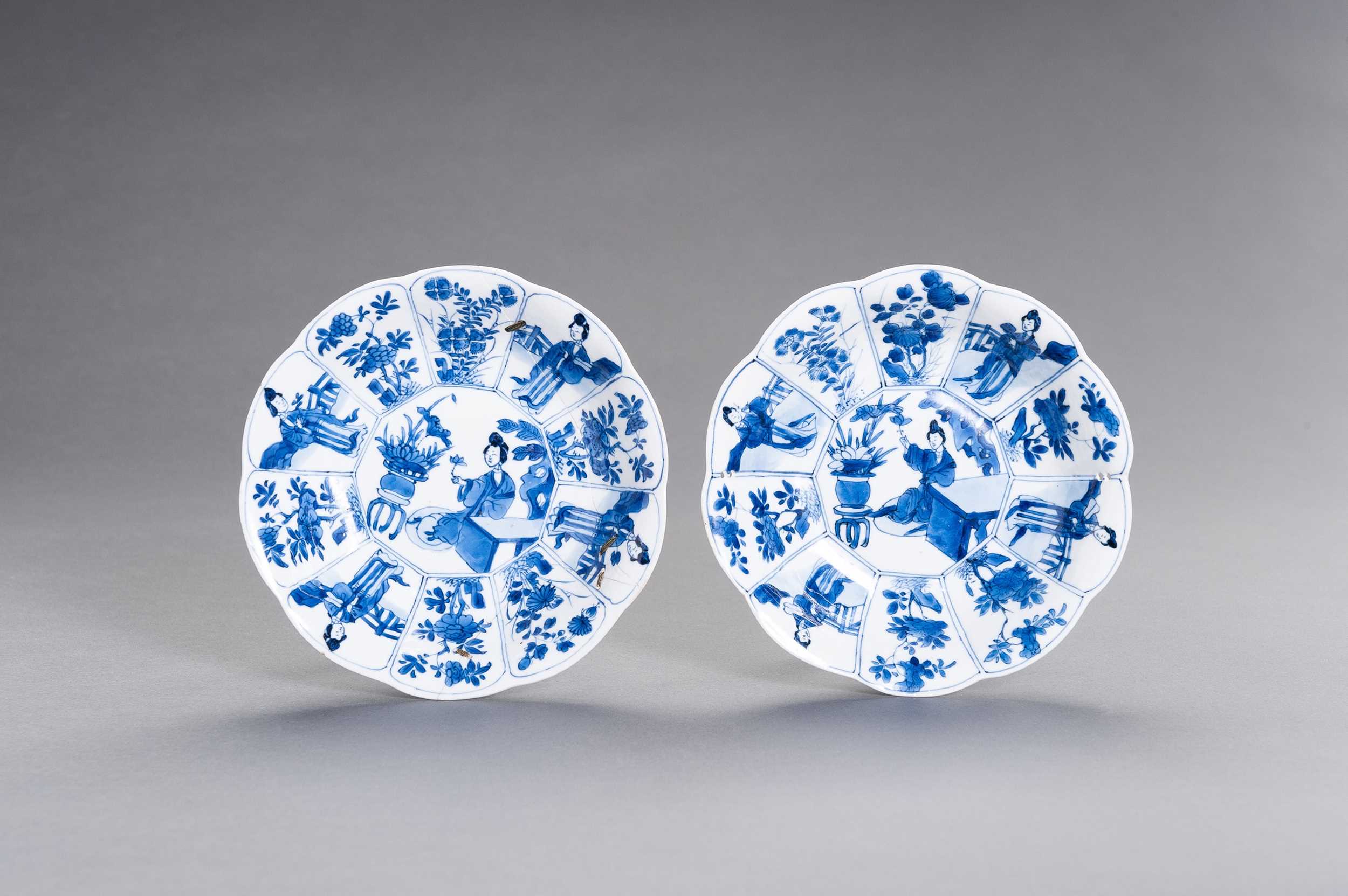Lot 325 - A PAIR OF BLUE AND WHITE ‘LADY IN GARDEN’ LOBED DISHES, KANGXI