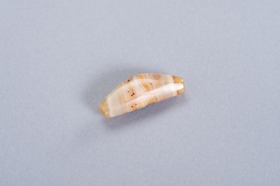Lot 222 - A SMALL OLD ‘CHUNG DZI’ BANDED AGATE BEAD
