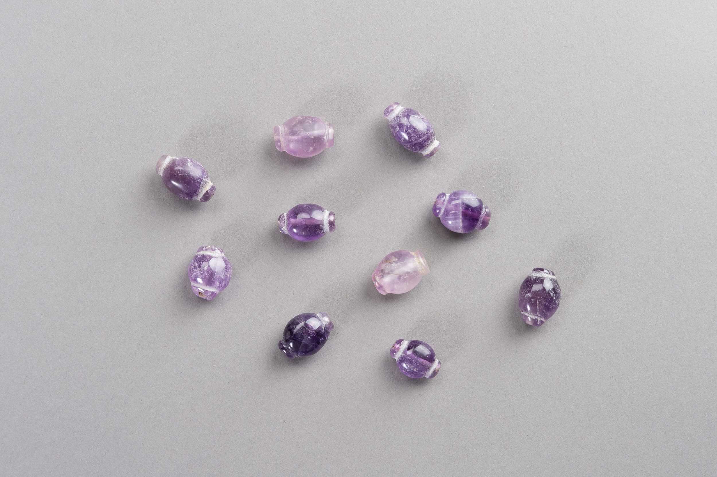 Lot 574 - A FINE LOT WITH TEN ANCIENT AMETHYST BEADS