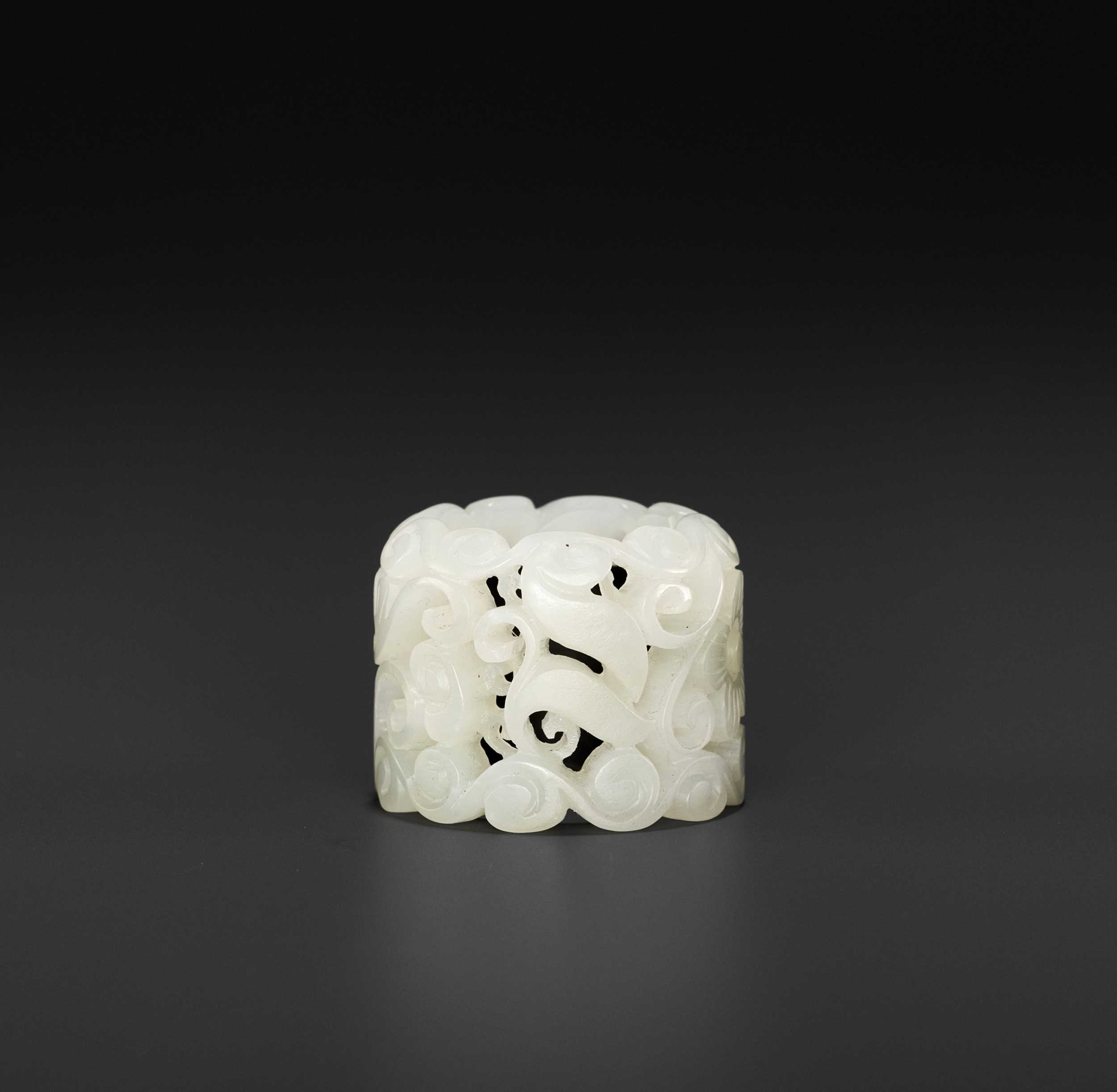 Lot 120 - A WHITE JADE OPENWORK ‘BAT’ ARCHER’S RING, MID-QING DYNASTY