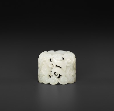Lot 120 - A WHITE JADE OPENWORK ‘BAT’ ARCHER’S RING, MID-QING DYNASTY