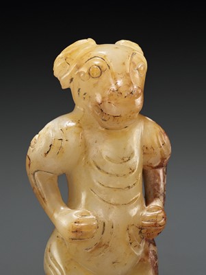 A YELLOW AND RUSSET JADE FIGURE WITH A RAM’S HEAD